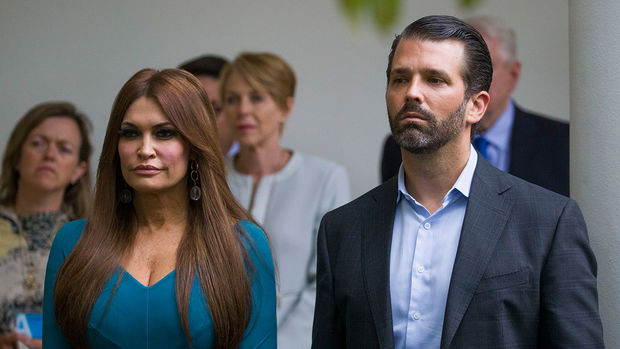 FILE- - In this July 11, 2019, file photo, Donald Trump Jr., the son of President Donald Trump, right, and his girlfriend Kimberly Guilfoyle, listen as President Donald Trump speaks about the 2020 census in the Rose Garden of the White House in Washington. (AP Photo/Alex Brandon, File)