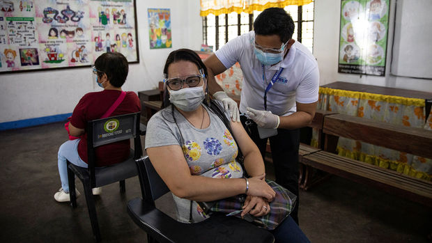 A woman participates in a simulation for COVID-19 vaccination in preparation for its arrival, at an elementary school turned vaccination command center in Pasig City, Metro Manila, Philippines, February 16, 2021. REUTERS/Eloisa Lopez