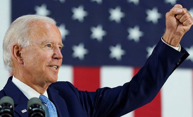FILE PHOTO: Democratic U.S. presidential candidate and former Vice President Joe Biden thrusts his fist while answering questions from reporters during a campaign event in Wilmington, Delaware, U.S., June 30, 2020. REUTERS/Kevin Lamarque/File Photo