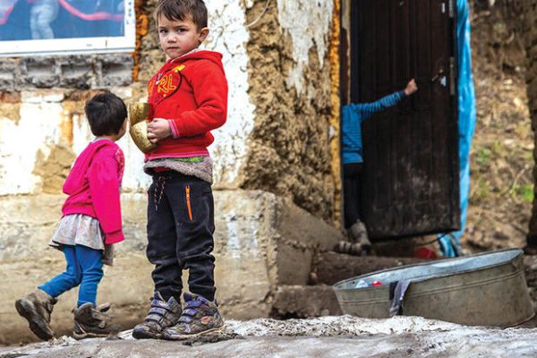 Velykyi Bereznyi, Ukraine - February 28, 2021: Group of cute gypsy kids in ghetto. Ukrainian Roma children in Carpathian mountains.