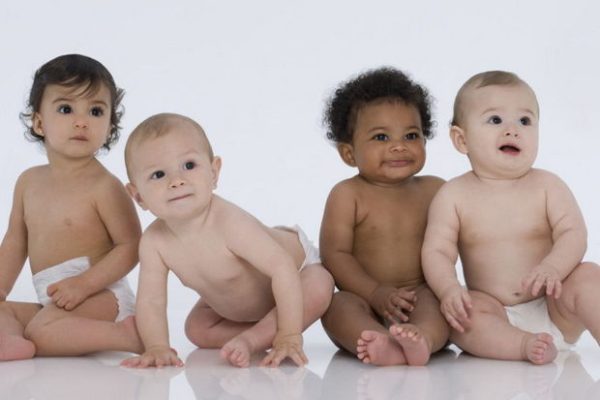 Four MultiEthnic Babies Sitting on White.